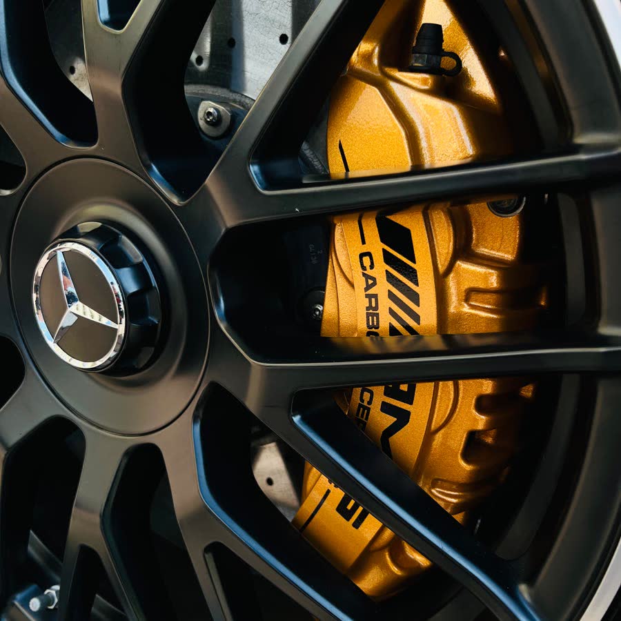 An AMG wheel and yellow brake caliper after cleaning.