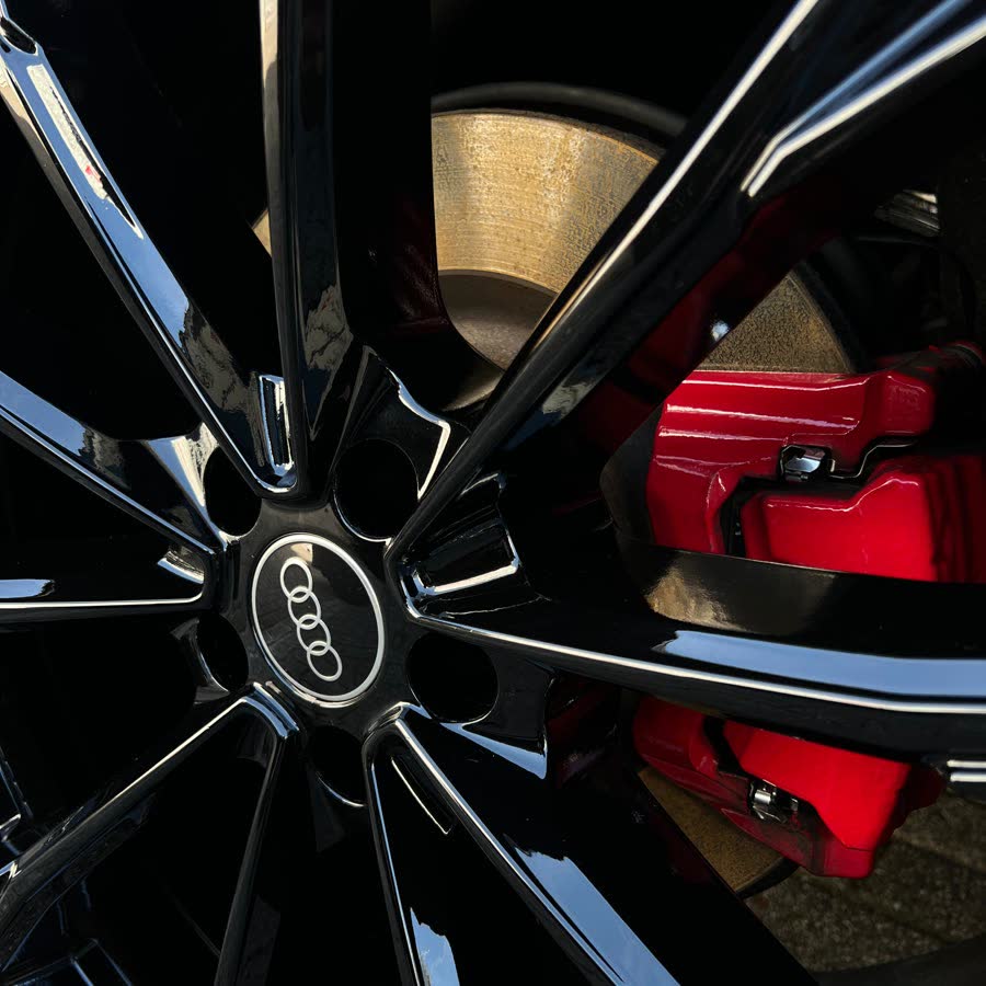 An Audi wheel with red brake calipers after cleaning.